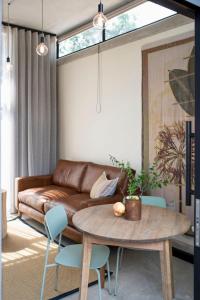 a living room with a table and a couch at Brooklyn Blok in Pretoria