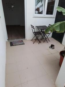 a room with a table and chairs on a tiled floor at Casa Rafter Abades in Abades