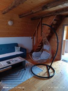 a living room with a blue couch and a swing at Durmitorski cvijet in Žabljak
