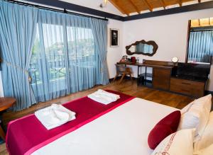 A bed or beds in a room at Porto Amore Club Hotel