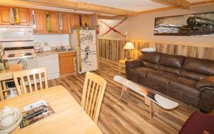 a living room with a couch and a table at ML132 Rustic Mountain Views Wi-Fi EZ Parking 1st Floor in Snowshoe