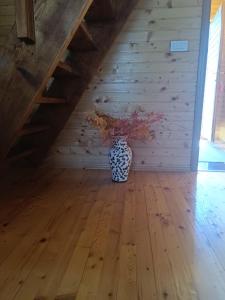 a vase sitting on the floor in a room with stairs at Durmitorski cvijet in Žabljak +32 photos
