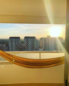 a view of a city skyline from a window at Apartamento New Wave - 2 quartos Setor Bueno in Goiânia
