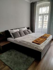 a bed sitting in a bedroom with a window at Mieszkanie na Nadodrzu in Wrocław