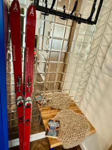 two red skis are on display in a room at Art & SunSki Studio z garażem podziemnym in Krynica Zdrój +96 photos