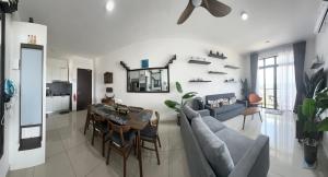 a living room with a couch and a table at Desaru Dhancell Executive Homestay Netflix,8Pax,Wifi in Desaru