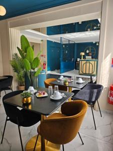 a dining room with blue cabinets and a table and chairs at La Caravelle in Aix-en-Provence