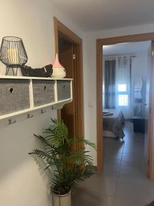 a living room with a mirror and a room with a plant at Apartamento en Moncofa in Moncófar