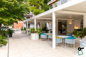 an outdoor patio with tables and stools at HOTIDAY Room Collection - Sorrento in Sorrento