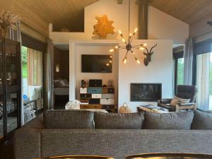 a living room with a couch and a tv at Riverside Cottage in Lundur