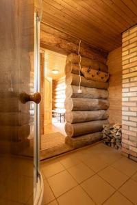 a bathroom with a shower in a log cabin at Nature Gem Lake House Ildzes in Vikstrauti