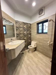 a bathroom with a sink and a toilet at Dream Inn Guest House Islamabad in Islamabad