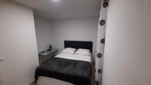 a bedroom with a bed in a white room at Apartman Iva in Podstrana