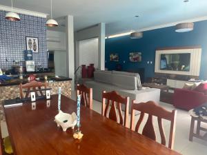 a living room with a table and chairs and a couch at Ocean front privacy and comfort! in Pitangui