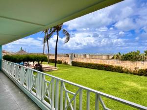 a balcony with a view of a yard at Ocean front privacy and comfort! in Pitangui