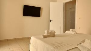 a bedroom with a bed with towels on it at Messinian Aura in Arkondikó