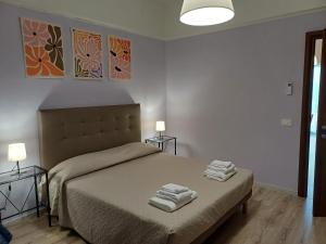 a bedroom with a bed with towels on it at Fuori dalle Mura Jesi in Iesi +14 photos