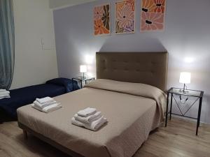 a bedroom with a bed with towels on it at Fuori dalle Mura Jesi in Iesi