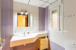 a bathroom with a sink and a mirror at Apartamento Confort Valderrobres in Valderrobres +17 photos