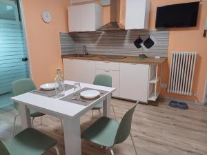 a kitchen with a table and chairs in a kitchen at Fuori dalle Mura Jesi in Iesi