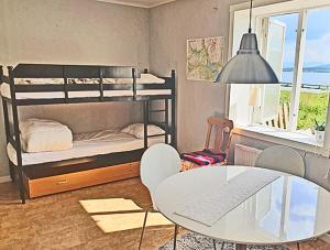 a room with two bunk beds and a table and a desk at Eternus Paradise in Tärnaby