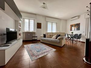 a living room with a couch and a television at Buddy'S House Lake view Dog friendly whit garage in Abbadia Lariana