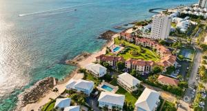 an aerial view of a resort next to the ocean at 7Mile Beachfront Apartment in George Town