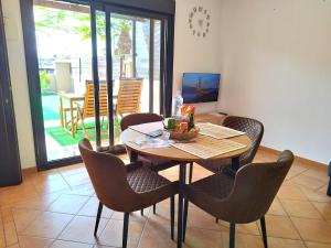 a dining room with a table and chairs and a patio at Casa La Ola Majanicho - Monthly Stays in Majanicho