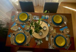 une table avec des bols et des plaques jaunes dans l'établissement Apartamento Primavera Centro, à Ronda