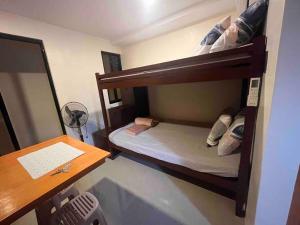 a small room with two bunk beds and a desk at Studio apartment in Mactan, Cebu Rm 202 in Mactan