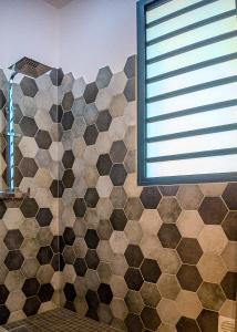 a bathroom with a tiled shower with a window at Les 3 sables, CAPUCIN in L'Étang-Salé les Bains +21 photos