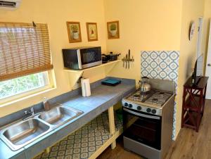 a kitchen with a sink and a stove at Mi Pana Apartments in Vieques +14 photos