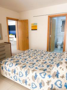 una camera da letto con un letto con un piumone blu e bianco di St Pauls Bay 2 bedrooms a San Pawl il-Baħar