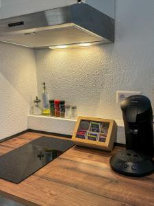 a kitchen counter with a coffee maker on top of it at FeWo Family Joy Apartment - by Europapark in Rust +6 photos