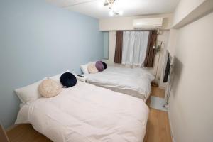 Postel nebo postele na pokoji v ubytování 花宿新宿 HANAYADO SHINJUKU