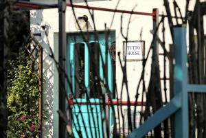 een bord aan de zijkant van een gebouw met een hek bij TUTTO House in Frýdlant nad Ostravicí