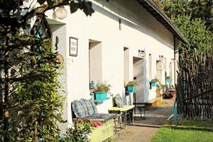 a white house with two chairs and a table at TUTTO House in Frýdlant nad Ostravicí