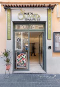 a pizza shop with a sign on the front of it at Hostal Oliveta Budget in Barcelona