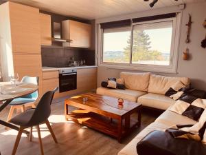 a living room with a couch and a table at MonacellA in Nonette