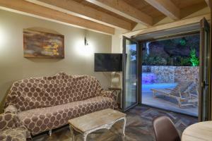 a living room with a couch and a sliding glass door at Alexandras's Mansion in Ayiá