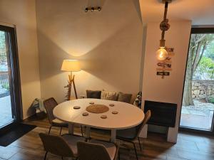 a dining room with a table and chairs at Pine House Novalja in Gajac