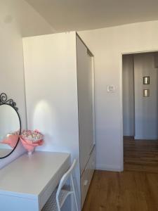 a white room with a mirror and a white cabinet at Może nad morze in Gdańsk