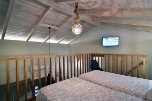 a bedroom with a bed and a tv on the wall at Alexandras's Mansion - Fragkia's House in Ayiá +71 photos