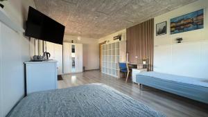 A bed or beds in a room at Pavillon Greve