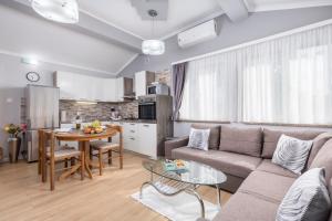 a living room with a couch and a table at Apartman Slavica in Rijeka