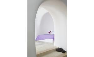 A bed or beds in a room at Perivolas Hotel