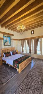 a bedroom with a large bed with a chandelier at nahrin hote & art in Sanlıurfa
