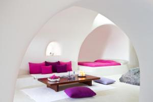 A bed or beds in a room at Perivolas Hotel