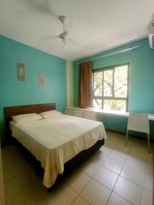 a bedroom with a large bed and a window at Apartamento Solar Rio Vermelho in Salvador