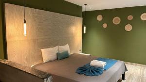 a bedroom with a bed with a green wall at LOL-HA Hotel Boutique in Cancún +32 photos